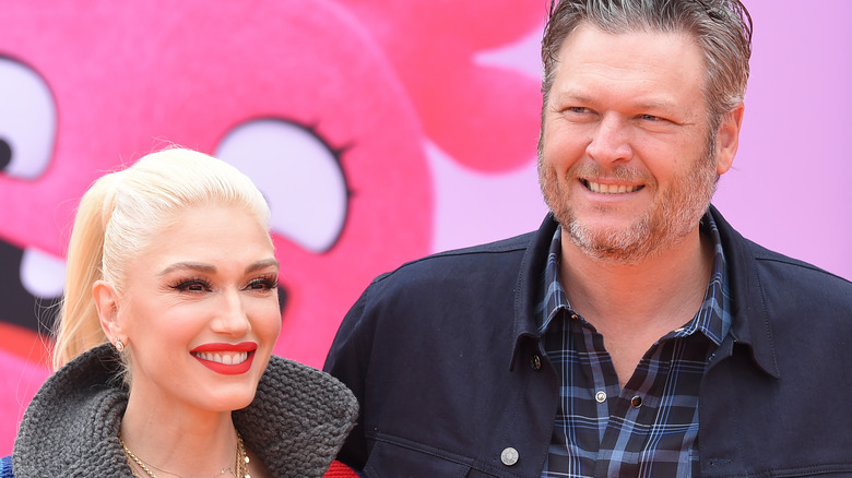 Gwen Stefani and Blake Shelton smile on red carpet