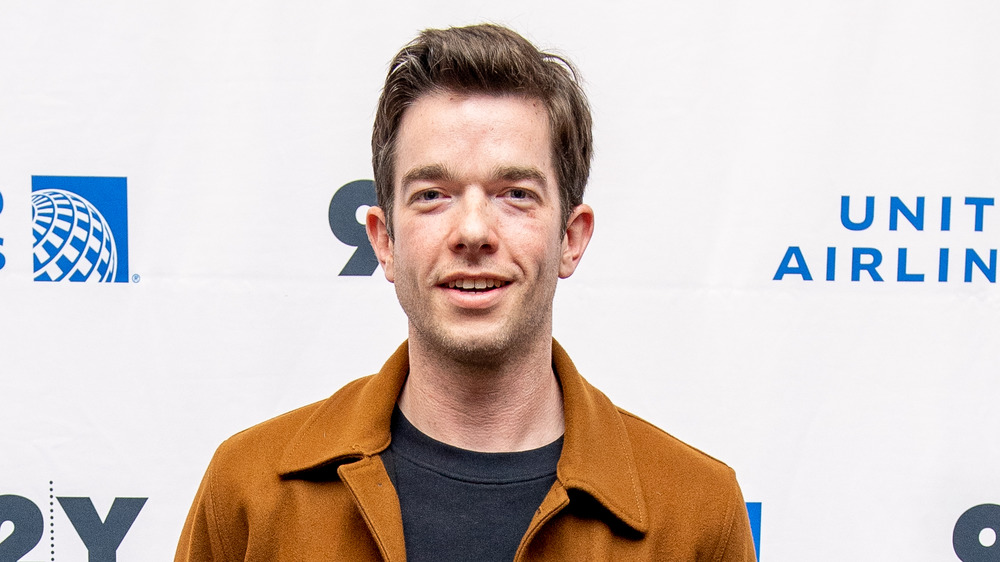 John Mulaney posing at an event