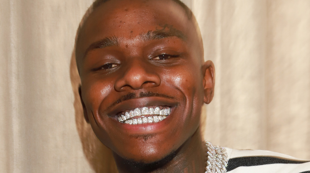 DaBaby grinning with silver teeth