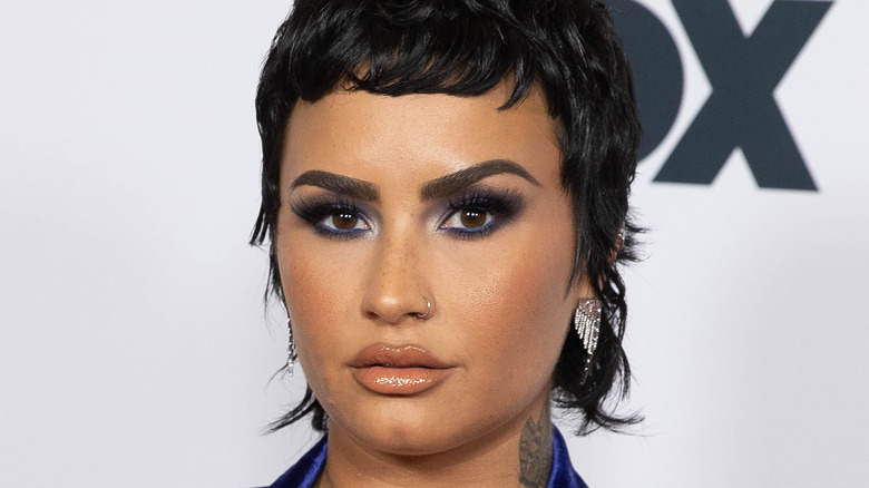 Demi Lovato poses on red carpet