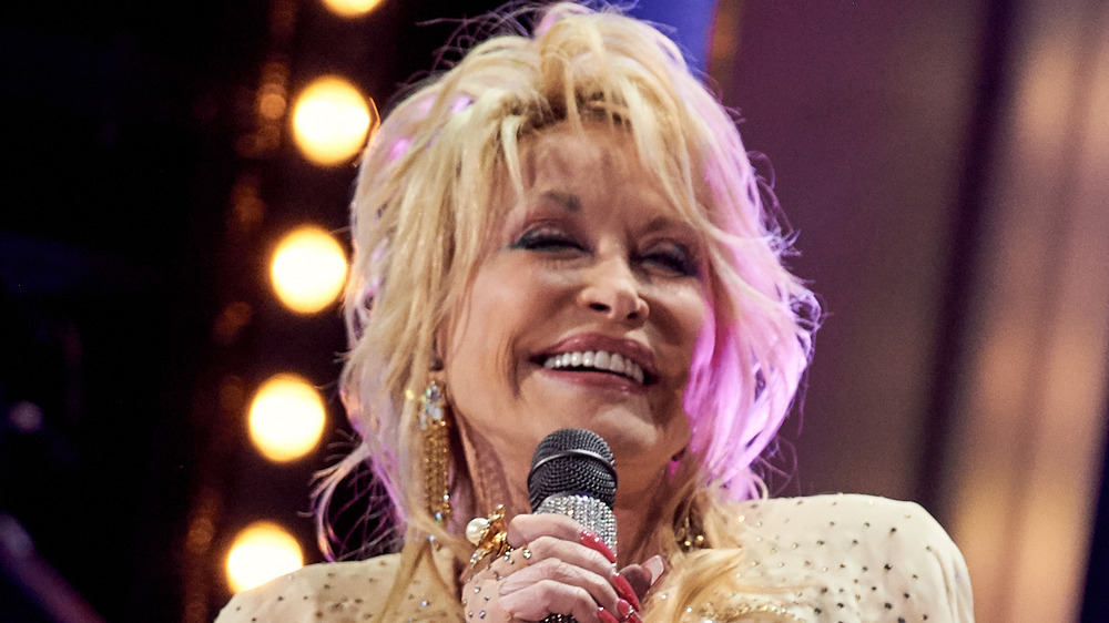 Dolly Parton holding a microphone