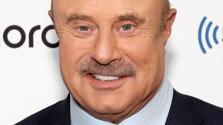 Dr. Phil smiles as he walks the red carpet