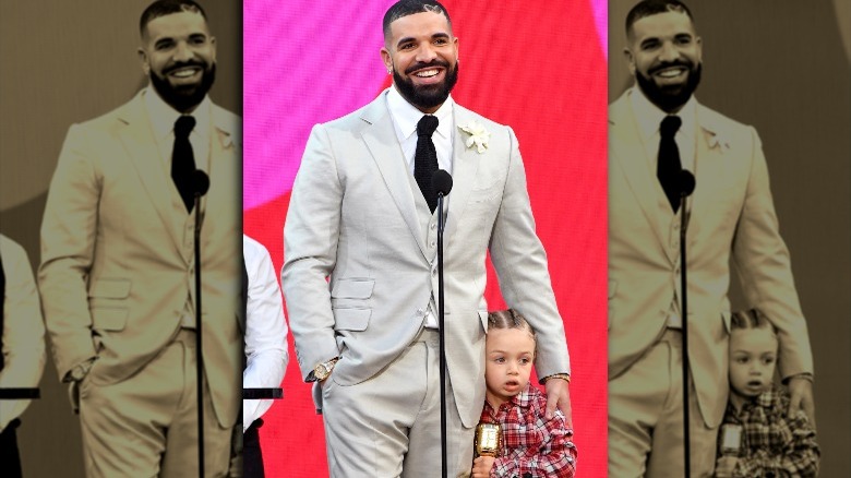 Drake holding Adonis Graham close