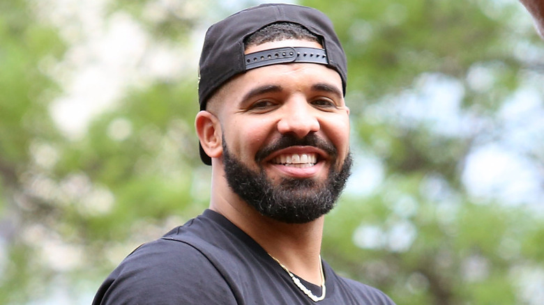 Drake wearing a backwards cap