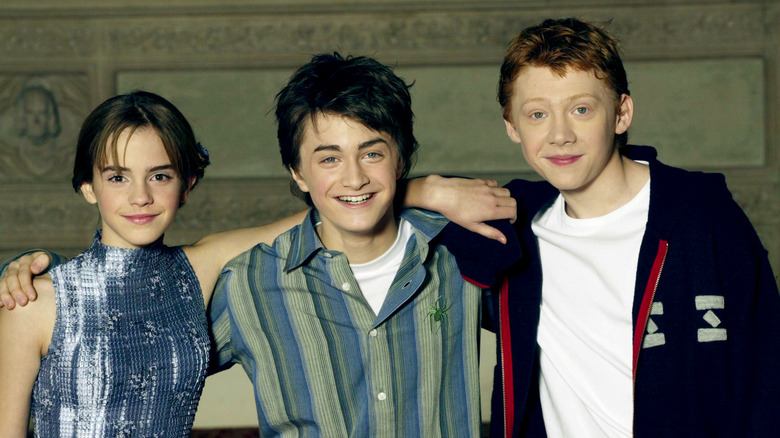 Emma Watson, Daniel Radcliffe, and Rupert Grint pose together in 2002