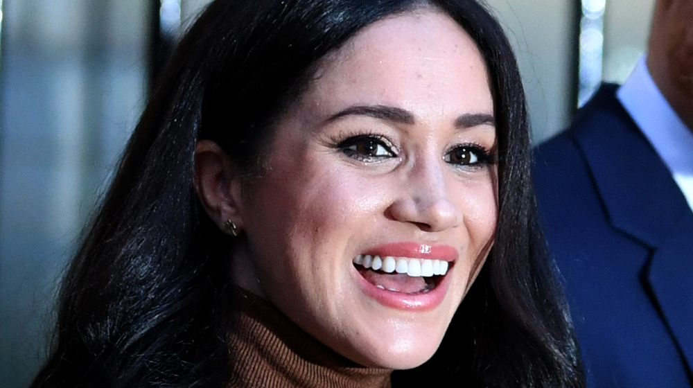 Meghan Markle and Prince Harry waving to fans