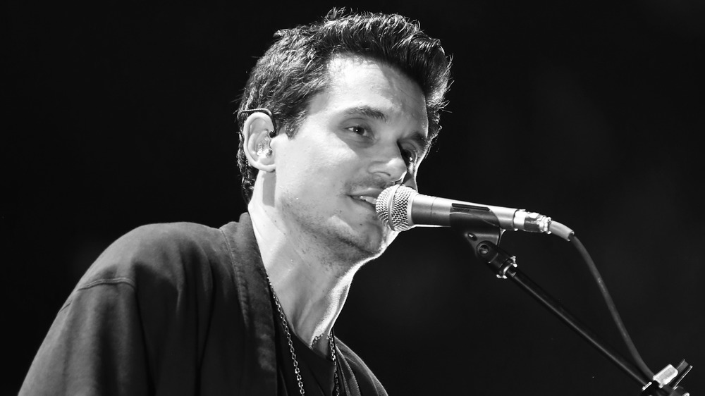 John Mayer playing guitar and singing