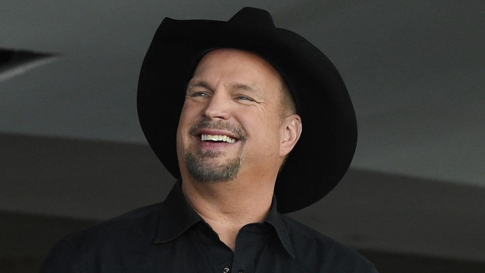 Garth Brooks smiles during a news conference 