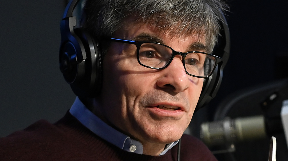 George Stephanopoulos sitting during an interview