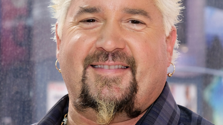 Guy Fieri smiles at an event