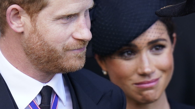 Prince Harry and Meghan Markle looking sad