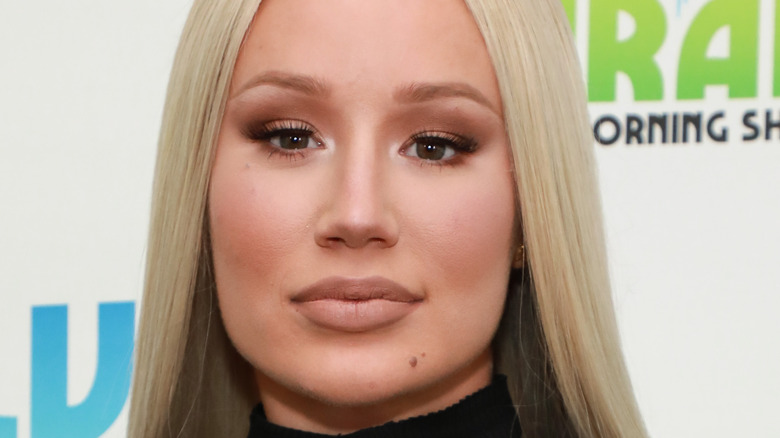 Iggy Azalea, not smiling, blond hair straight down, 2019 radio appearance 