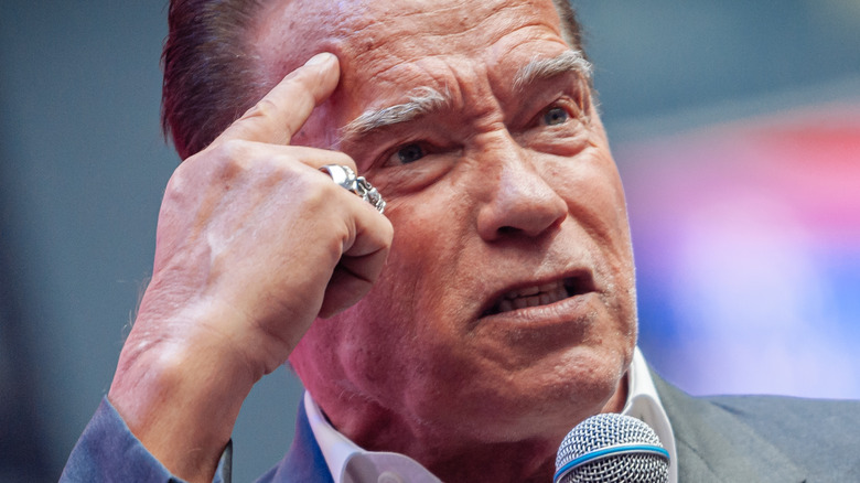 Arnold Schwarzenegger finger on forehead
