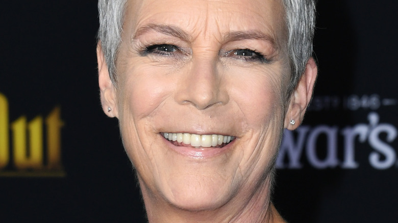 Jamie Lee Curtis smiles in a dark outfit in 2019.