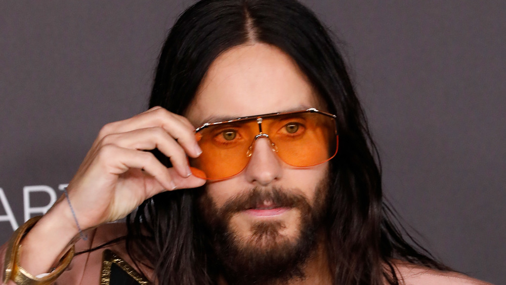 Jared Leto adjusts sunglasses