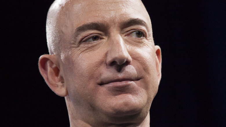 Jeff Bezos smirks at an event
