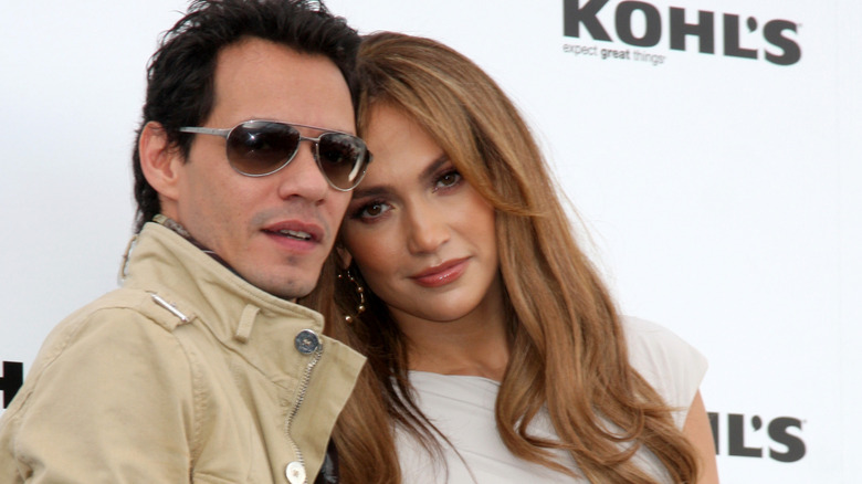 Jennifer Lopez leaning on Marc Anthony