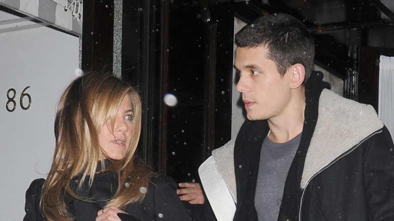 John Mayer and Jennifer Aniston exiting a building