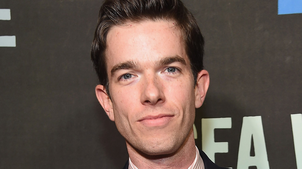 John Mulaney with a microphone