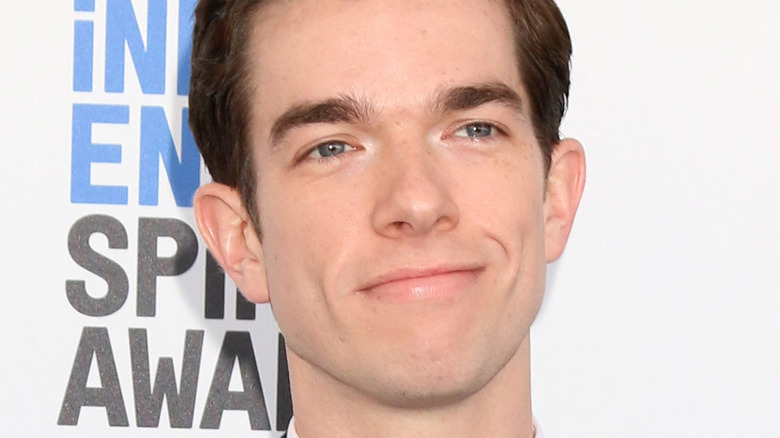 John Mulaney smiling at an event