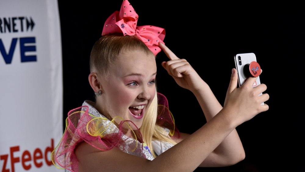 JoJo Siwa poses in one of her signature bows