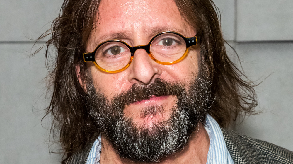 Judd Nelson smiling slightly 