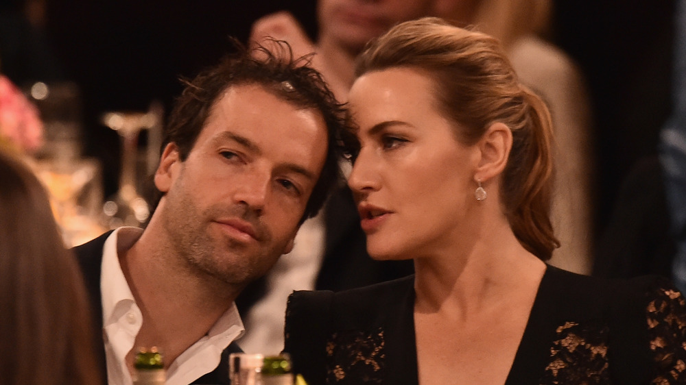 Kate Winslet whispering into husband Ned Rocknroll's ear