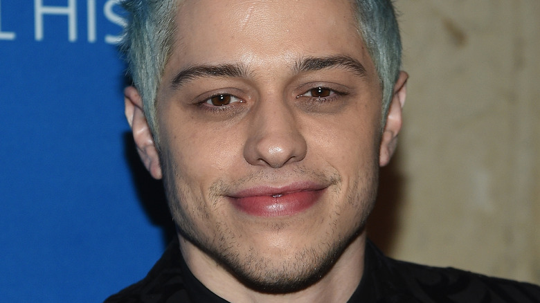 Pete Davidson smiles at an event