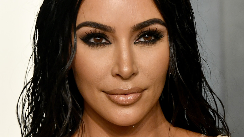 Kim Kardashian, 2020 Oscars party, half smiling, her black hair down, wearing makeup