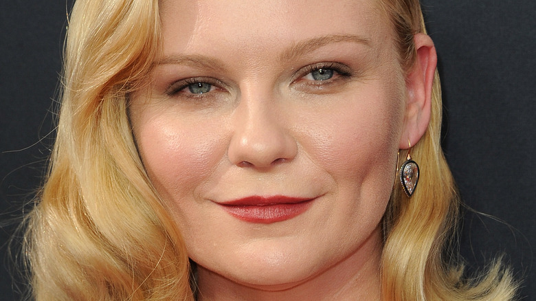 Kirsten Dunst poses in red lipstick