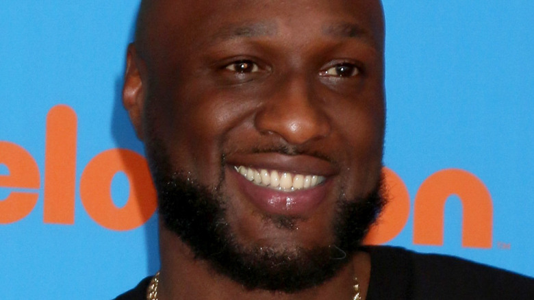 Lamar odom smiling on red carpet 