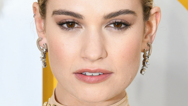 Lily James wears diamond dangle earrings