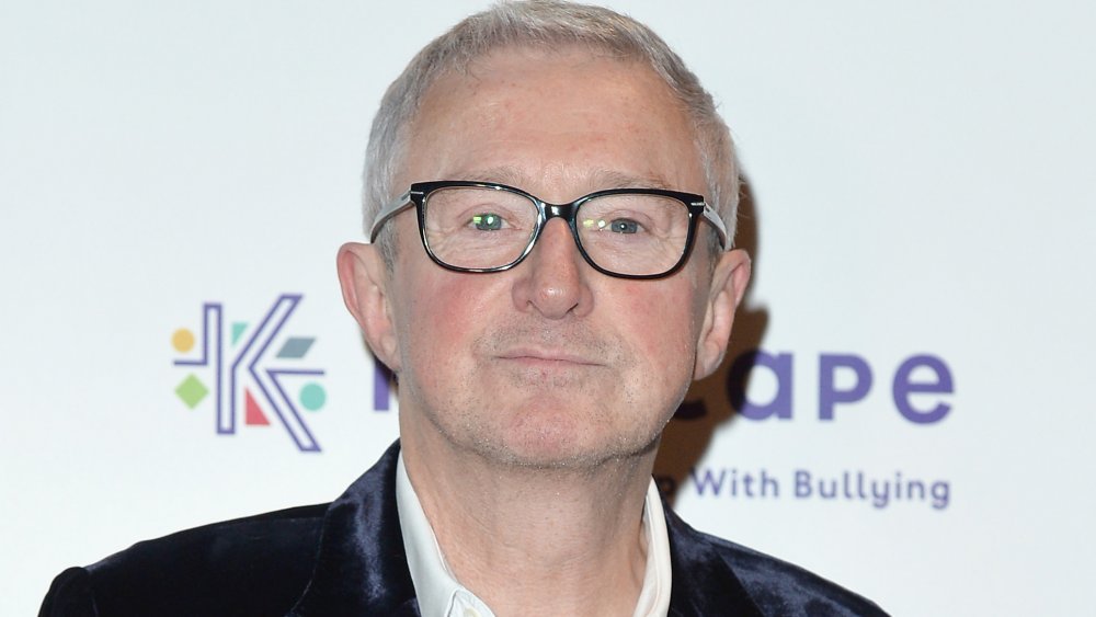 X Factor judge Louis Walsh in high spirits as he walks past Brown