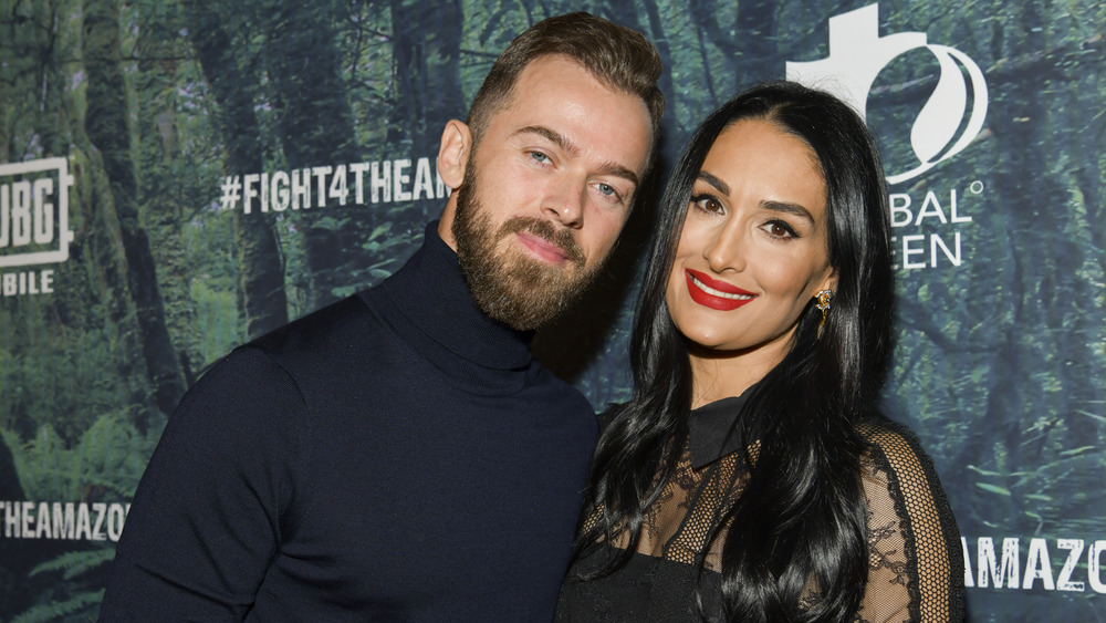 Artem Chigvinstev and Nikki Bella on a red carpet