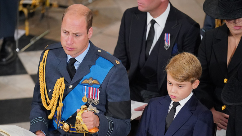 Prince William sitting next to Prince George