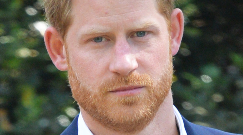 Prince Harry staring with a serious expression