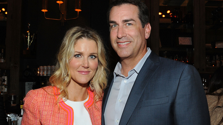 Tiffany Riggle and Rob Riggle pose together at an evening event