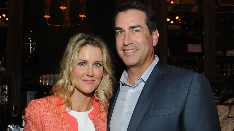 Tiffany Riggle and Rob Riggle pose together at an evening event