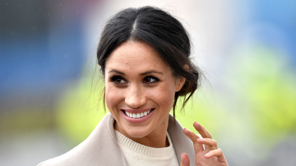 Meghan Markle waves at crowd