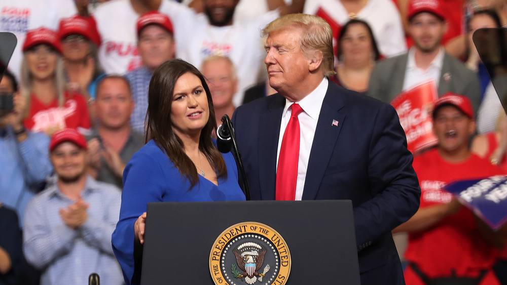 Sarah Huckabee Sanders and Donald Trump on stage