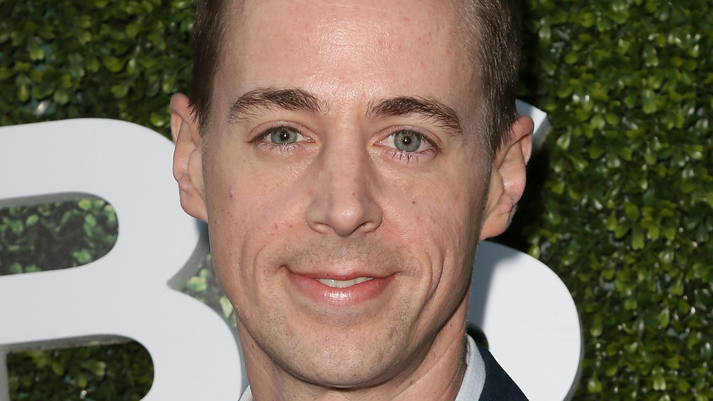 Sean Murray smiles in a dark suit