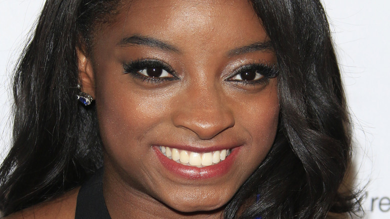 Simone Biles smiles at an event