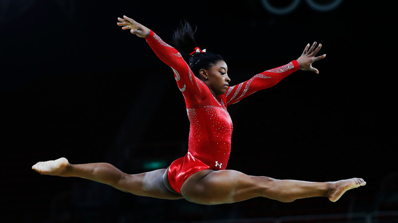 Simone Biles leaping through the air