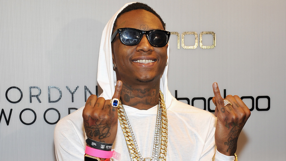 Soulja Boy gestures at an event