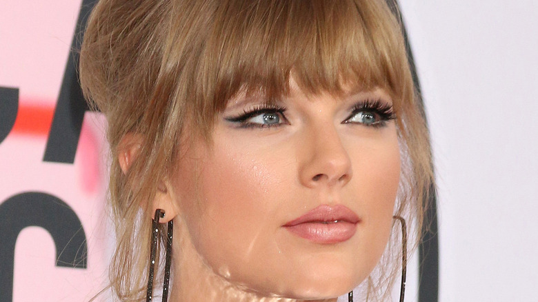 Taylor Swift gazes at the camera on the red carpet