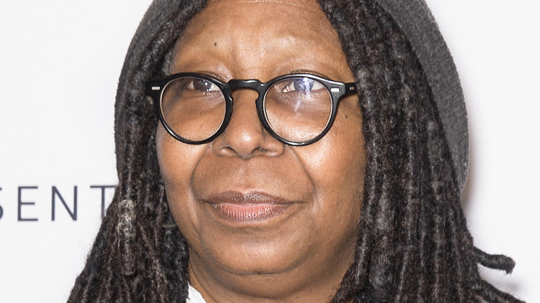 whoopi goldberg ghost walking in heels Whoopi Goldberg with a serious expression