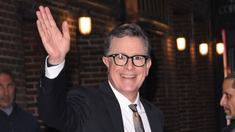 Stephen Colbert waves and smiles