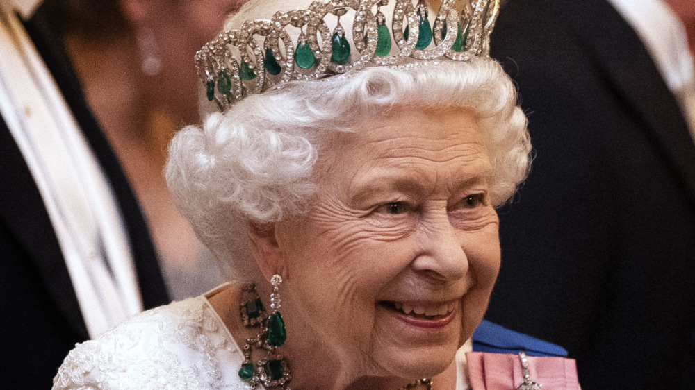 The queen smiling at a royal event