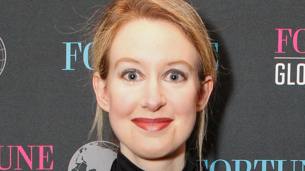 Elizabeth Holmes smiling with wide eyes