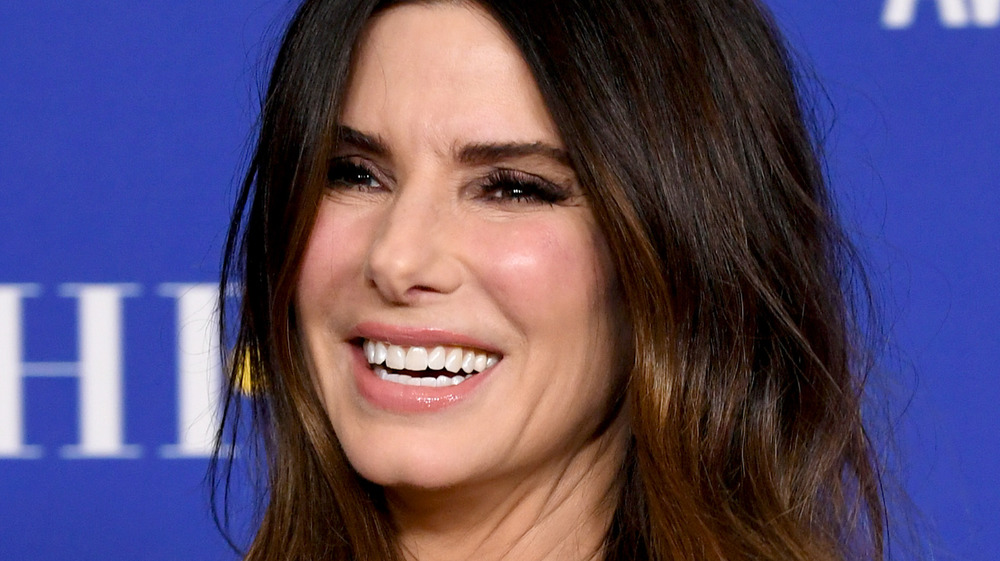 Sandra Bullock smiling on the Golden Globes red carpet